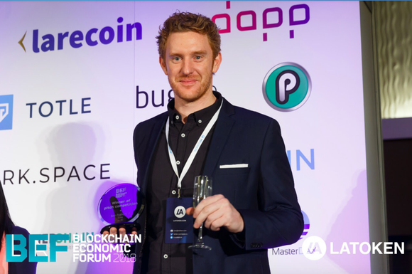 PlayChip advisor Luke Lombe with the Draper Hero’s Choice Award at the Blockchain Economic Forum